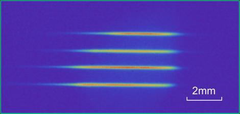 Fluorescence image of four laser-cooled atomic ensembles, each used as a quantum node in an entanglement distribution experiment by the Kimble group.